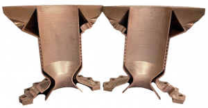 A cross-sectioned thrust chamber built on a Velo3D Sapphire system in GRCop-42 copper alloy. The chamber walls contain internal channels for regenerative cooling (Courtesy Velo3D)